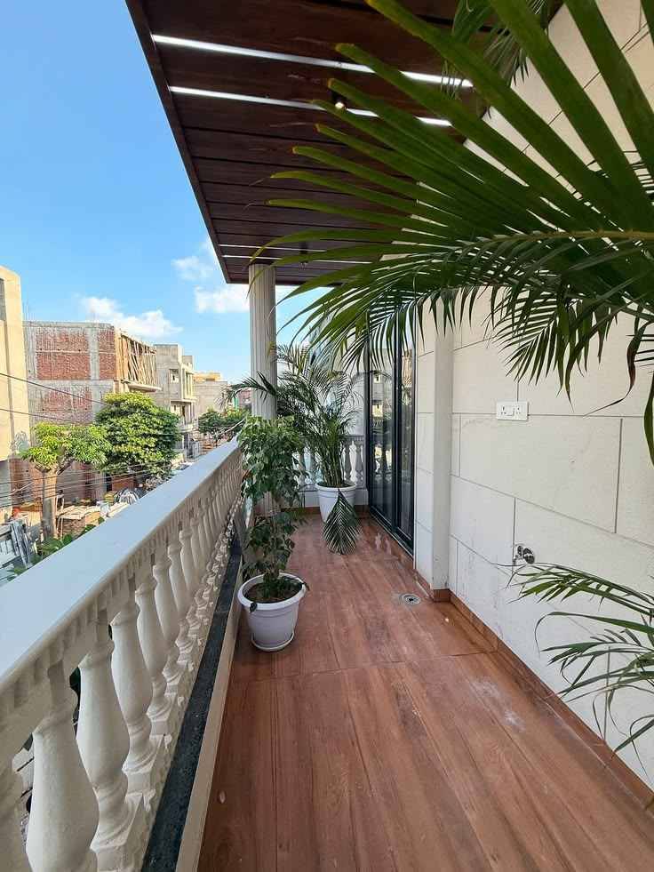 Luxury Balcony Garden with Wooden Deck and Panoramic City View | OMR image 2